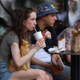 Customer holds a dog while drinking out of a white plastic cup at a rebranded McDonald's restaurant in Russia.